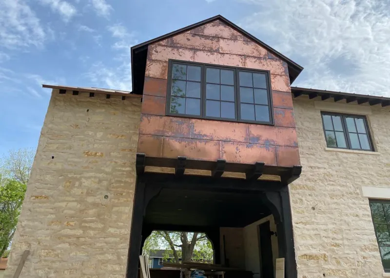 Copper metal panel facade on a stone building for Roof Repair in Village of Oak Creek (Big Park)